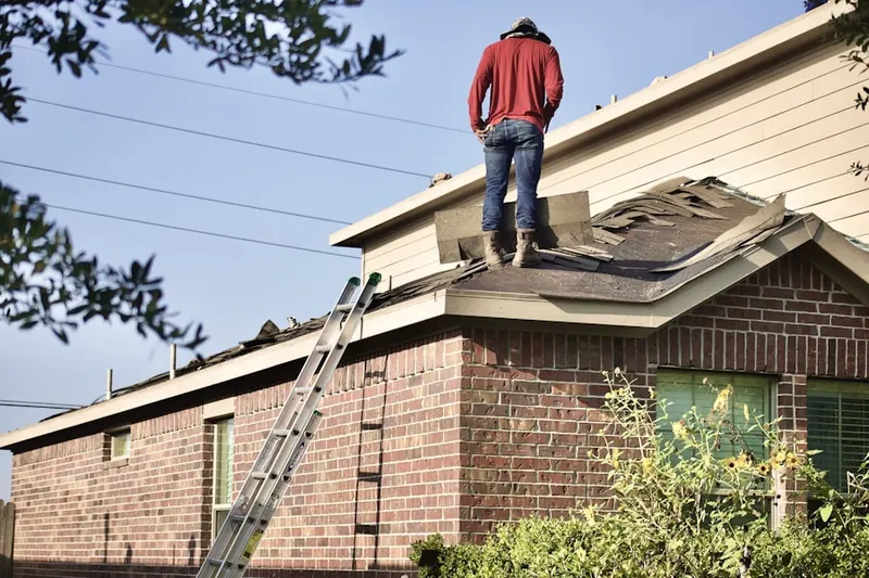 Professional roofer working on a residential roof in Montrose